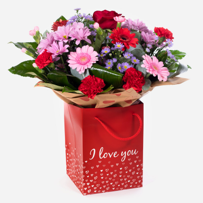 Mrs Kisses - Send lots of love and kisses with this classic hand-tied bouquet featuring a selection of romantic flowers finished with a luxurious single red rose.
