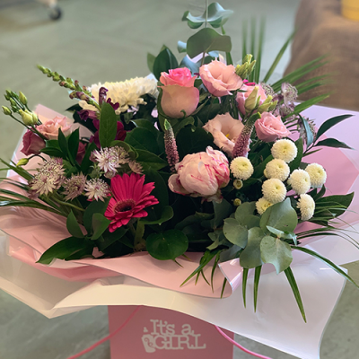 It's a Girl - A beautiful handtied presented in water in created using the fresh blooms of the day in pinks and whites with complementary foliage.