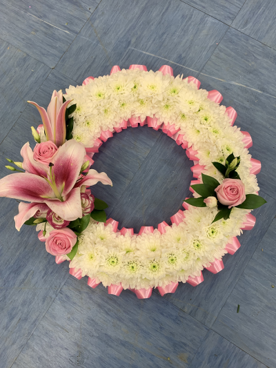 Scented Pink FunScented Pink Funeral Wreatheral Wreath - 14 inch Based Wreath, Pink Ribbon Edge and Pink Sprays
Foliage Edge and Other Colours Available