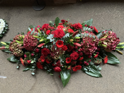 Casket Spray Reds - Seasonal Red Casket Spray
Depending On Seasonal Availability Some Flowers May Different